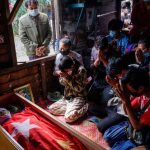 Mourners pray